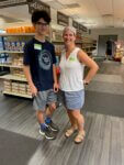 Westbay marketplace volunteers standing together in front of non-perishable food goods.